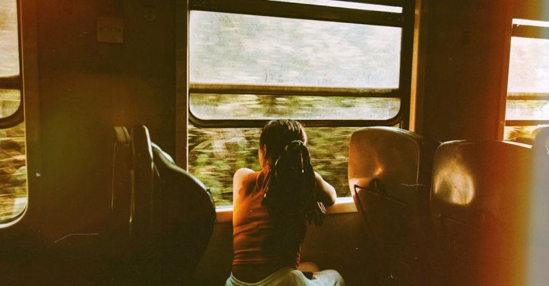 Transitions - Unrecognizable woman riding train and looking out window