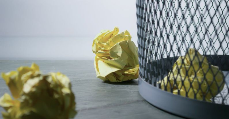 Rejection - Focus Photo of Yellow Paper Near Trash Can