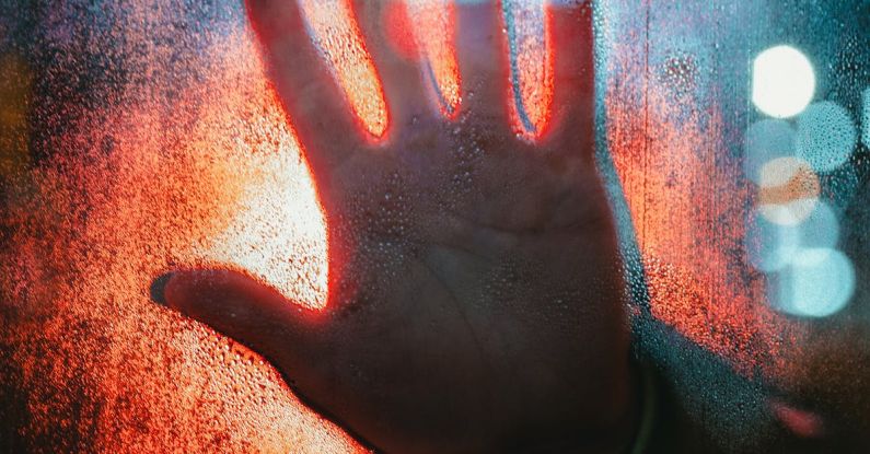 Isolation - Hand Touching Glass